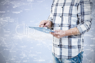 Composite image of mid section of man using tablet computer