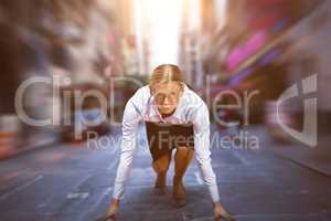 Composite image of business woman in the starting blocks