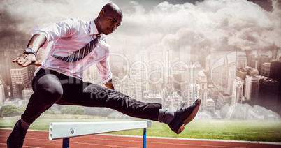 Composite image of businessman jumping a hurdle