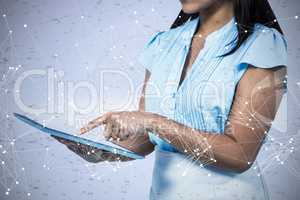 Composite image of cropped image of businesswoman using tablet