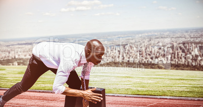 Composite image of close up of businessman in starting blocks