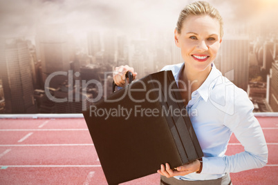 Composite image of businesswoman holding briefcase