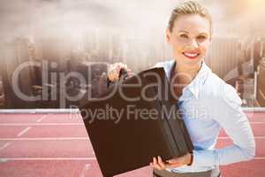 Composite image of businesswoman holding briefcase