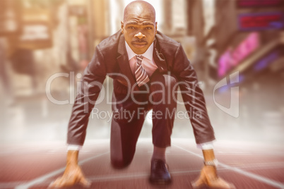 Composite image of close up of businessman in starting blocks