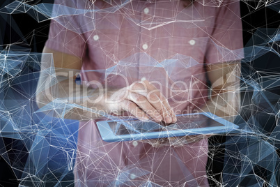 Composite image of mid section of hipster using digital tablet