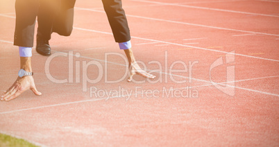 Composite image of businessman in the starting blocks