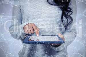 Composite image of mid section of asian woman using tablet