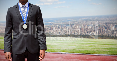 Composite image of businessman with medal