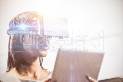 Businesswoman looking her tablet while using a virtual glasses