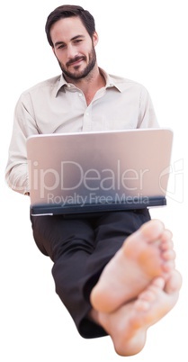 Smiling man using a laptop