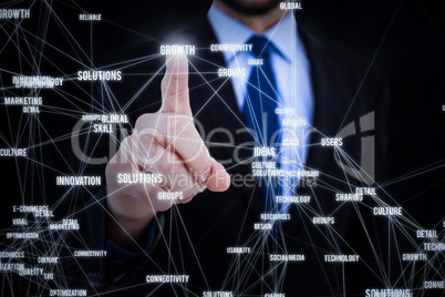 Composite image of businessman pointing his finger at camera