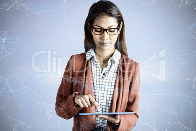 Composite image of businesswoman with eyeglasses using a tablet