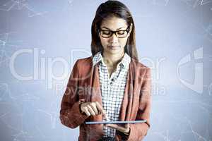 Composite image of businesswoman with eyeglasses using a tablet