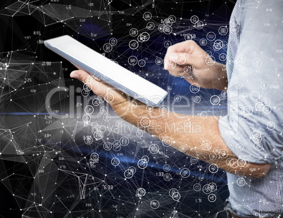 Composite image of businessman using digital tablet over white b