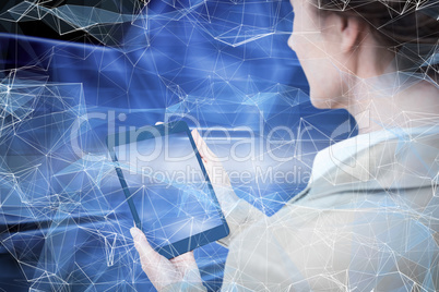 Composite image of businesswoman holding digital tablet on white