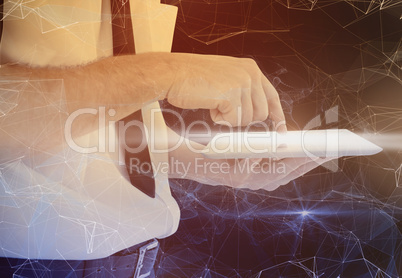 Composite image of businessman scrolling on his tablet pc