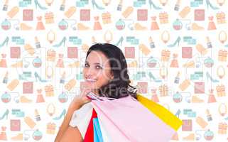 Composite image of pretty brunette with shopping bags