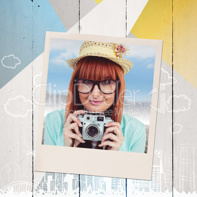 Composite image of portrait of a smiling hipster woman holding r