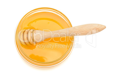 pot with honey and drizzler on a white background