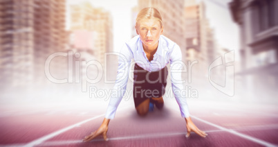 Composite image of businesswoman in the starting blocks