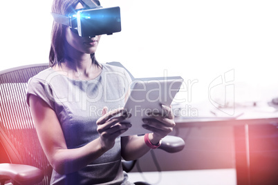 Businesswoman looking her tablet while using a virtual glasses