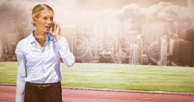 Composite image of smiling businesswoman on the phone