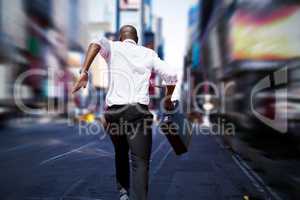 Composite image of businessman jumping a hurdle