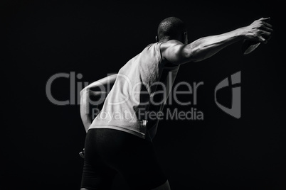 Composite image of rear view of sportsman practising discus thro