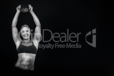 Composite image of female athlete holding discus