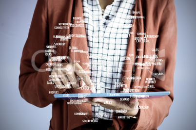 Composite image of businesswoman using a tablet