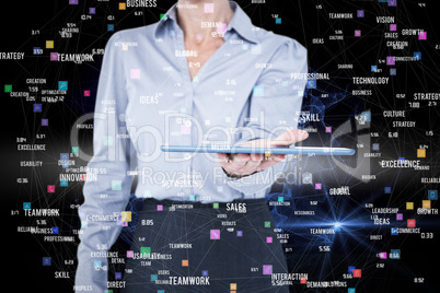 Composite image of businesswoman holding digital tablet