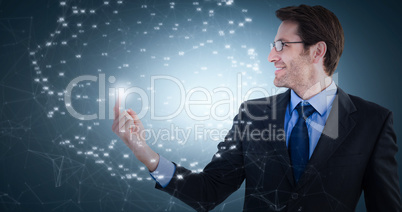 Composite image of smiling businessman pointing at a copy space