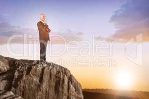 Composite image of happy businessman looking away