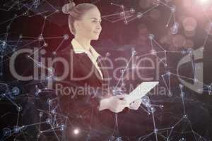 Composite image of businesswoman holding tablet
