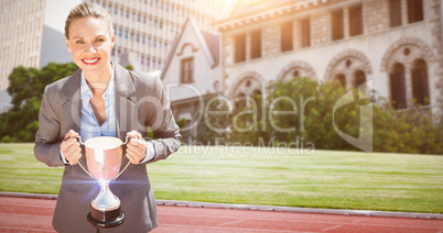 Composite image of businesswoman holding a cup