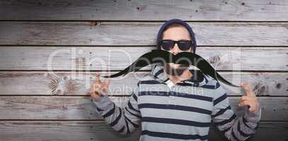 Composite image of portrait of happy hipster wearing sunglasses