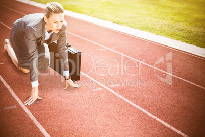 Composite image of businesswoman in starting position