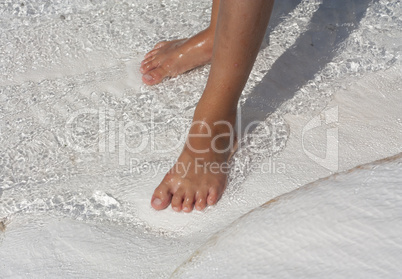 Foot in water natural travertine pools and terraces, cotton castle, Pamukkale, Turkey photo