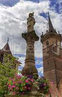 Sainte-Odile fountain and Kappelturm in Obernai village, Alsace,