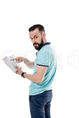 Studio photo of handsome bearded man with book