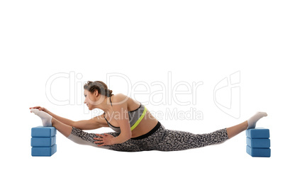 Woman doing stretching using gymnastic bricks