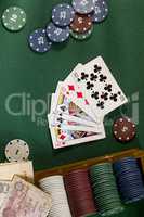 Cards with poker hand with chips and money