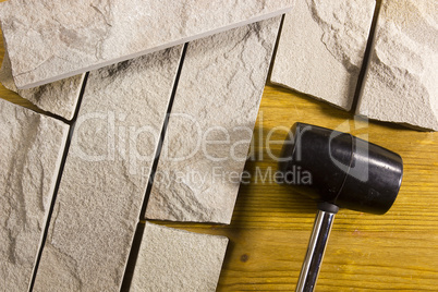 Black rubber mallet and facing stones