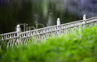 Horizontal diagonal fence in park bokeh background backdrop