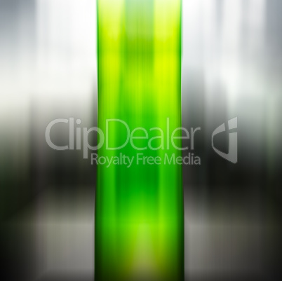 Vertical green motion blurred column on black and white backgrou