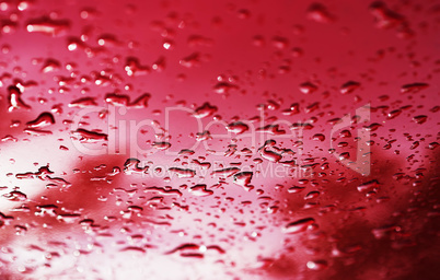 Red water drops after rain bokeh background