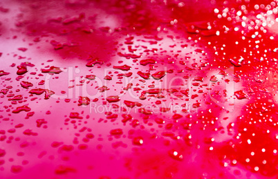 Red water drops after rain bokeh background