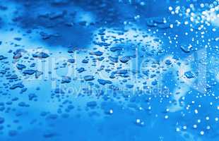 Blue drops after rain bokeh background