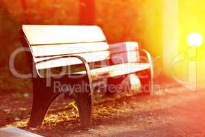 Horizontal sunset park bench in light bokeh background