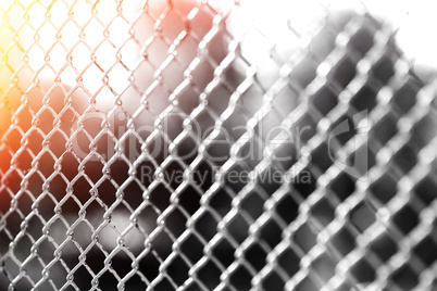Horizontal prison fence with light leak bokeh background